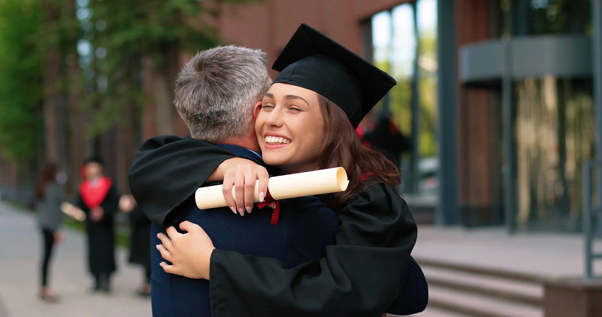 Happy graduate hugging her parent after the ceremony, representing ongoing parental duties and legal responsibility for supporting a child beyond age 18 under South African law
